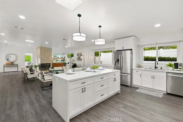 a kitchen with stainless steel appliances granite countertop a stove and a wooden floors