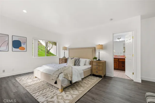 a spacious bedroom with a bed and a couch