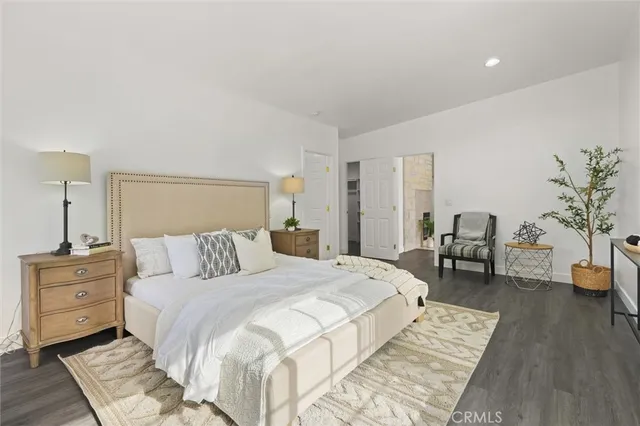 a bedroom with a large bed and a couch