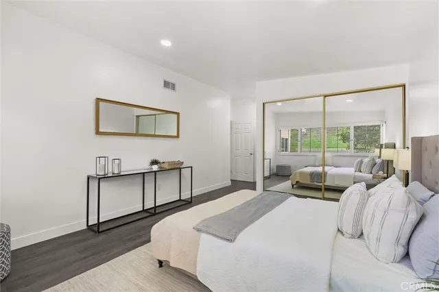 a bedroom with a bed window and a couch