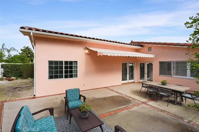 a backyard of a house with outdoor seating
