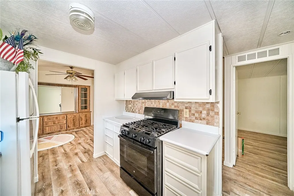 4000 Pierce Street, Unit 168 Riverside, CA 92505 - Photo 10 of 34 a kitchen with a stove a sink and a refrigerator