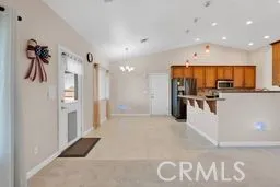 a view of kitchen with refrigerator and window
