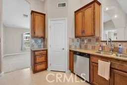 a kitchen with stainless steel appliances granite countertop a stove a microwave and a sink
