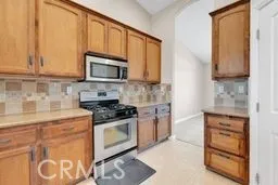 an empty room with window and ceiling fan