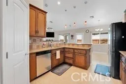 a large kitchen with stainless steel appliances granite countertop a sink and dishwasher a stove with wooden floor
