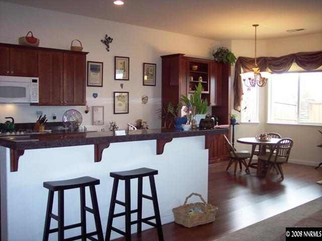 1687 Gemtown Drive Reno, NV 89521 - Photo 3 of 9 a kitchen with a table chairs and a dining room