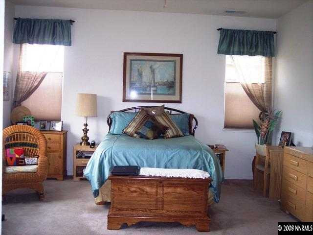 1687 Gemtown Drive Reno, NV 89521 - Photo 7 of 9 a bedroom with a bed and a painting on the wall