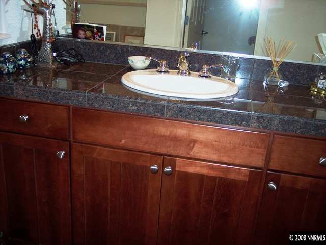 1687 Gemtown Drive Reno, NV 89521 - Photo 8 of 9 a bathroom with a granite countertop sink and a mirror