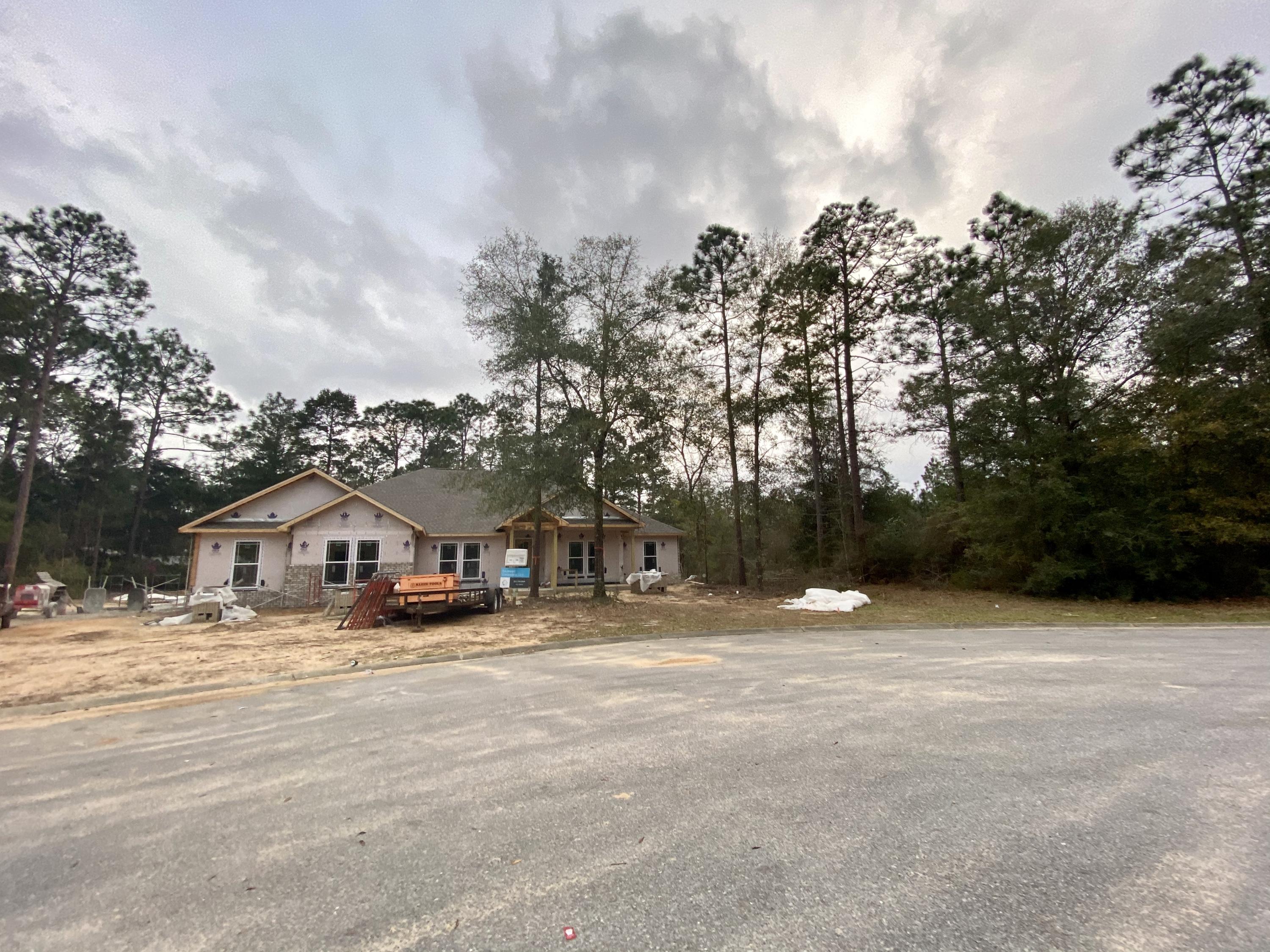 6080 Carina Road Crestview, FL 32539 - Photo 2 of 14 a swimming pool with buildings in background