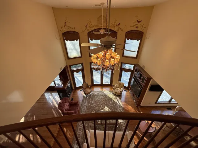 a view of an entryway wooden floor and chandelier