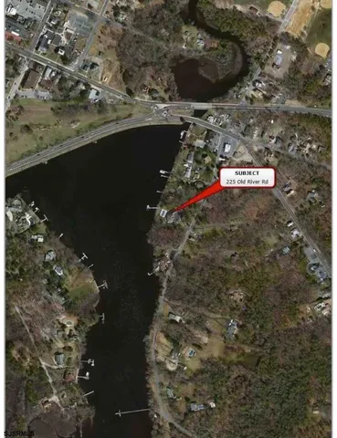 a view of staircase with wooden floor and white walls