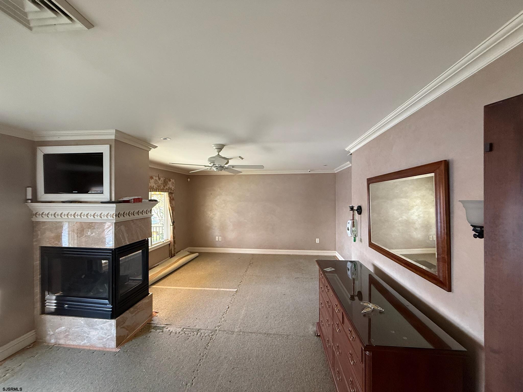 225 Old River Road Mays Landing, NJ 08330 - Photo 41 of 97 a view of a livingroom with a flat screen tv a ceiling fan and front door