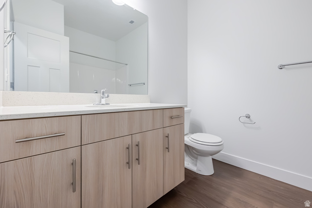 4727 South 690th West, Unit W301 Mapleton, UT 84664 - Photo 7 of 16 Wood-finish vanity with ample storage, a light-colored countertop, and a large wall-mounted mirror