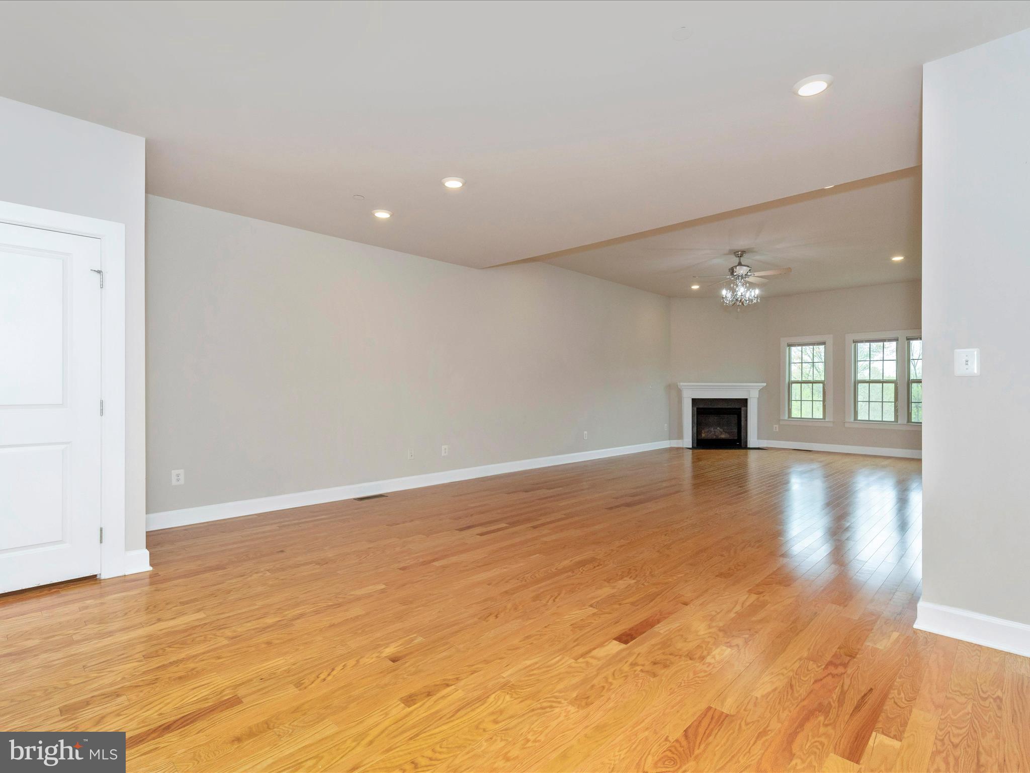 3838 Fulham Road Frederick, MD 21704 - Photo 11 of 51 a view of empty room with wooden floor and windows