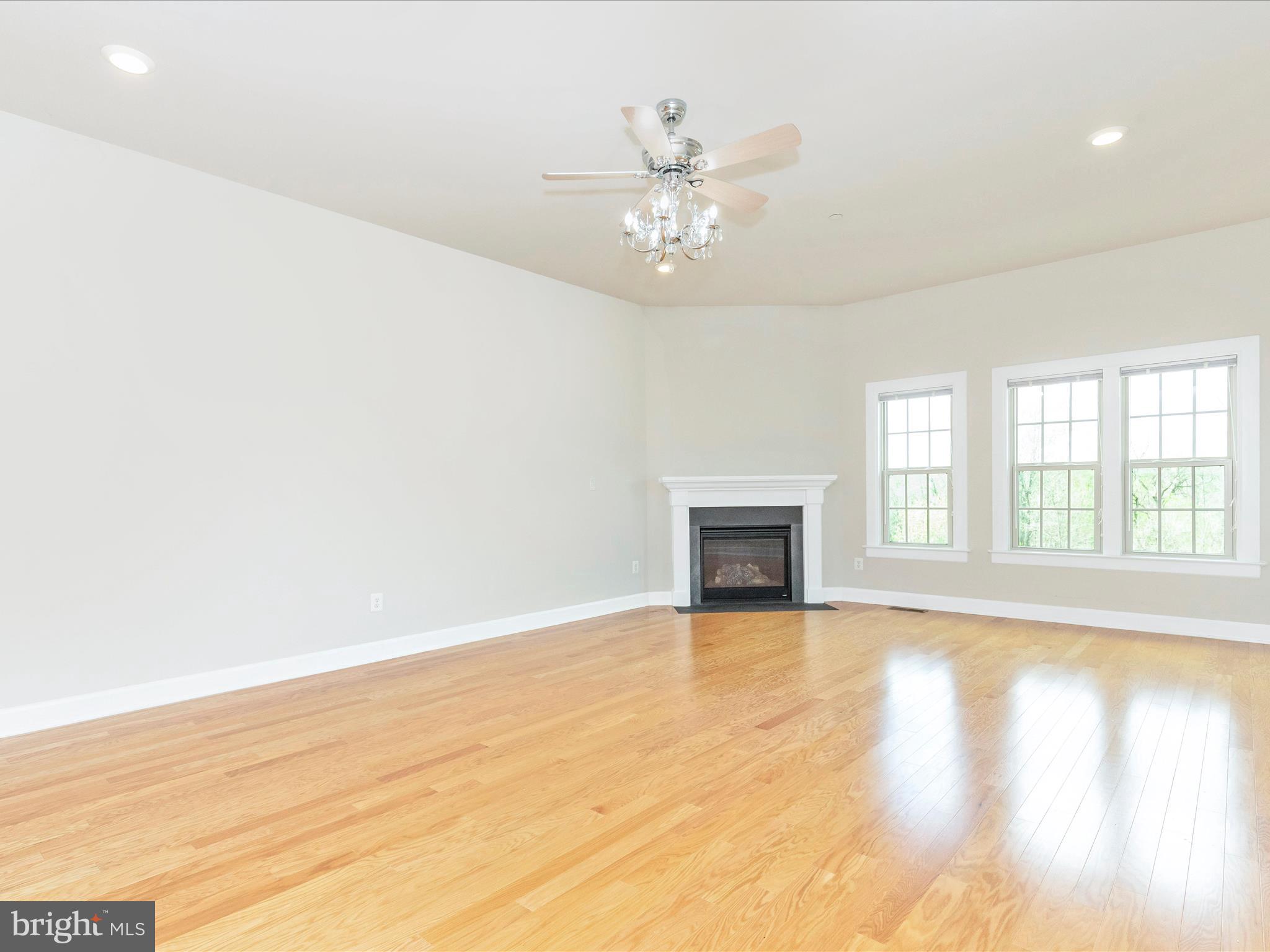 3838 Fulham Road Frederick, MD 21704 - Photo 13 of 51 a view of an empty room with wooden floor and a window