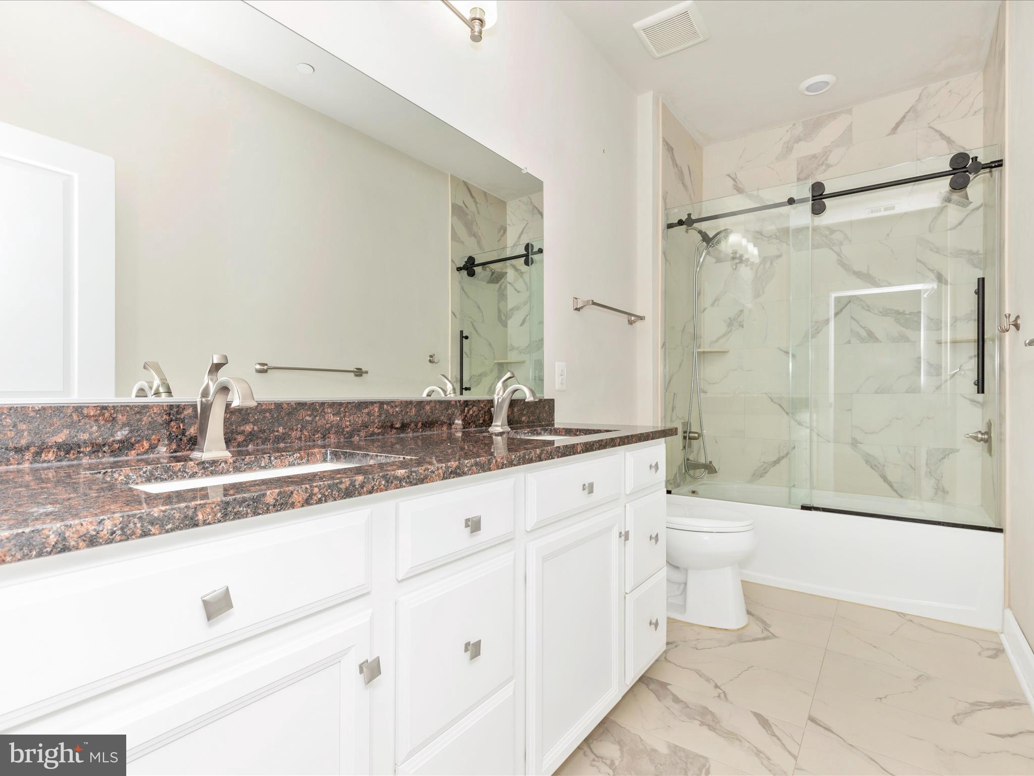 3838 Fulham Road Frederick, MD 21704 - Photo 26 of 51 a bathroom with a granite countertop sink toilet a mirror and shower