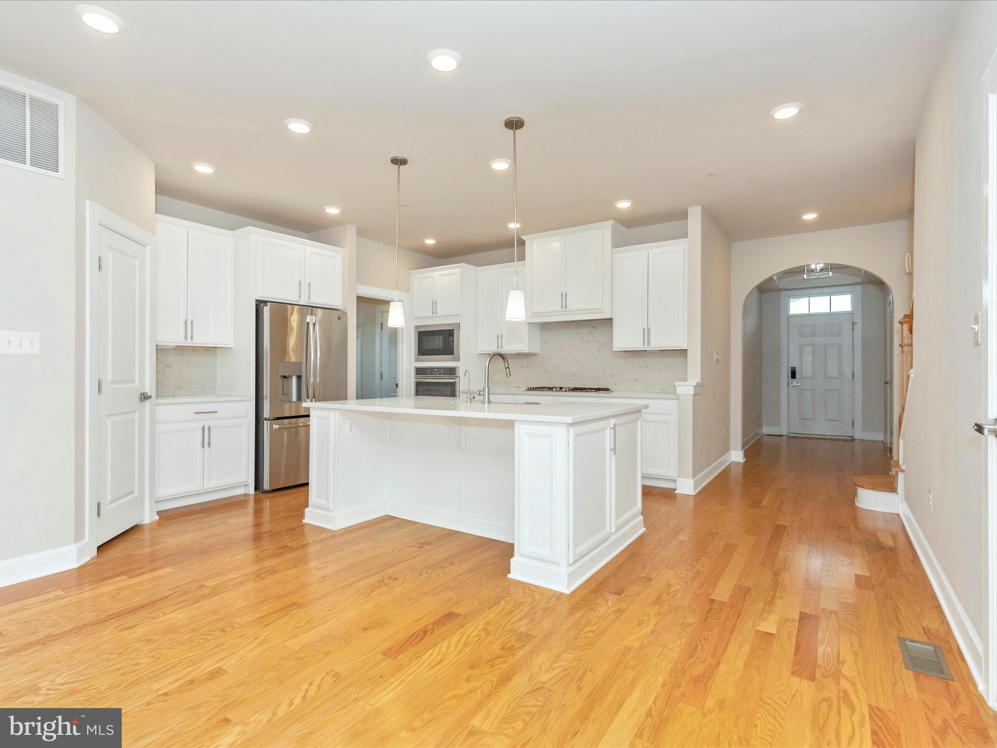 3838 Fulham Road Frederick, MD 21704 - Photo 5 of 51 a large white kitchen with a refrigerator a sink and a stove