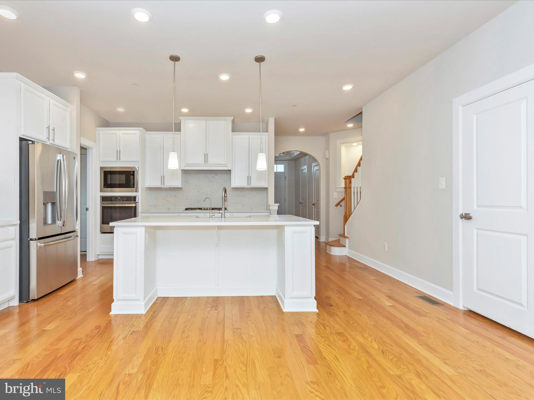 3838 Fulham Road Frederick, MD 21704 - Photo 6 of 51 a large kitchen with stainless steel appliances kitchen island a large counter top and a refrigerator