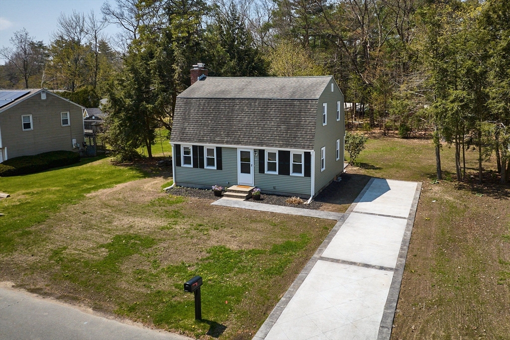 a aerial view of a house with swimming pool and porch