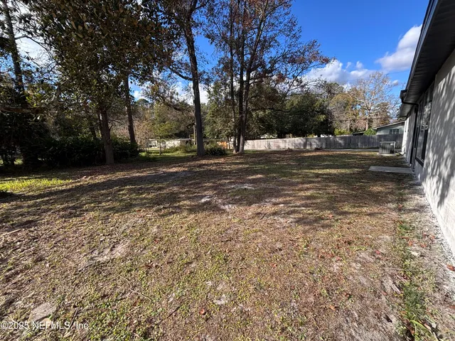 a view of a yard with a tree
