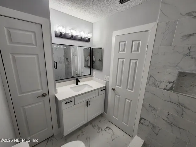 a bathroom with a double vanity sink and mirror