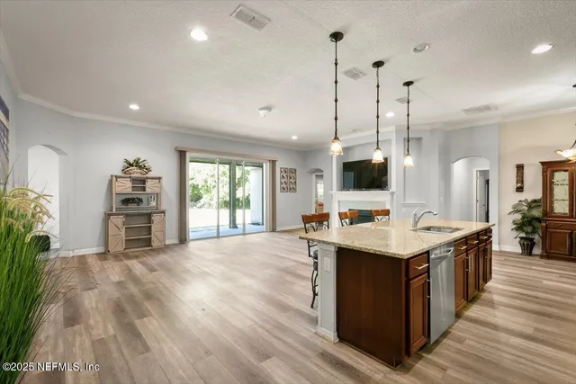 a kitchen with a stove and a wooden floor