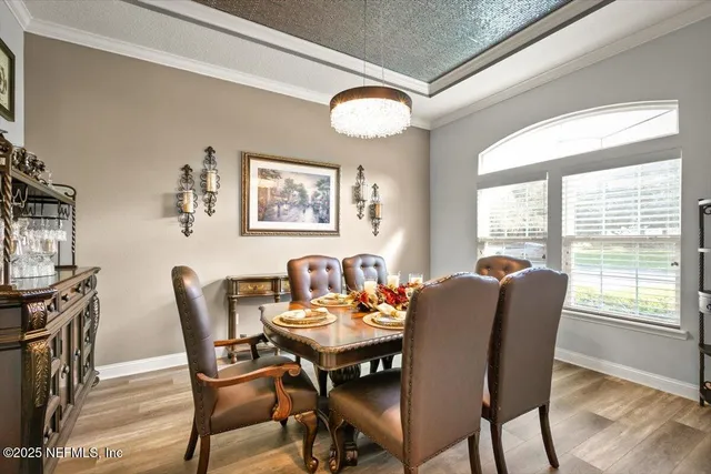 a view of a dining room with furniture window and wooden floor
