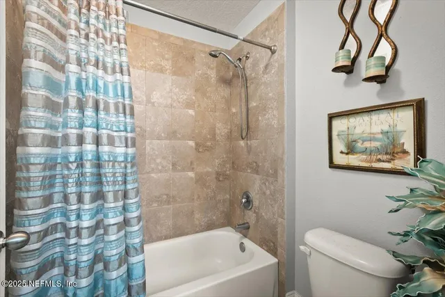 a bathroom with a toilet a sink and bathtub