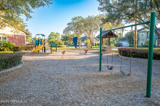 a view of a park with swings and slides