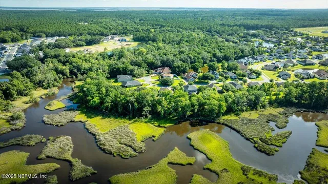 view of a lake with green space