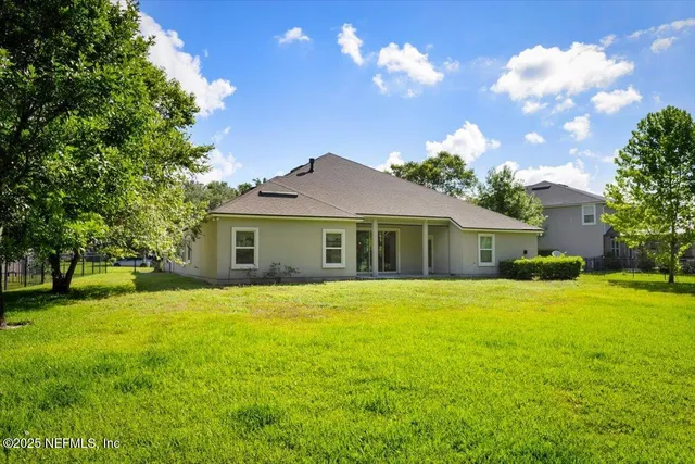 a front view of house with yard and green space