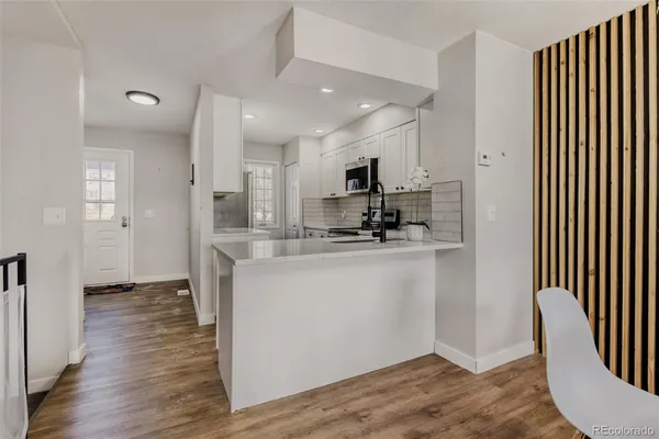 a view of kitchen and kitchen with wooden floor