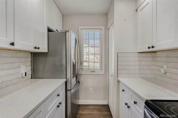 a kitchen with a refrigerator and sink