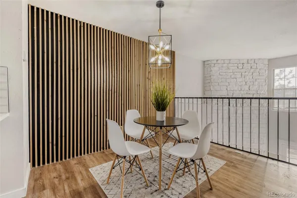 a view of a room with furniture wooden floor and front door
