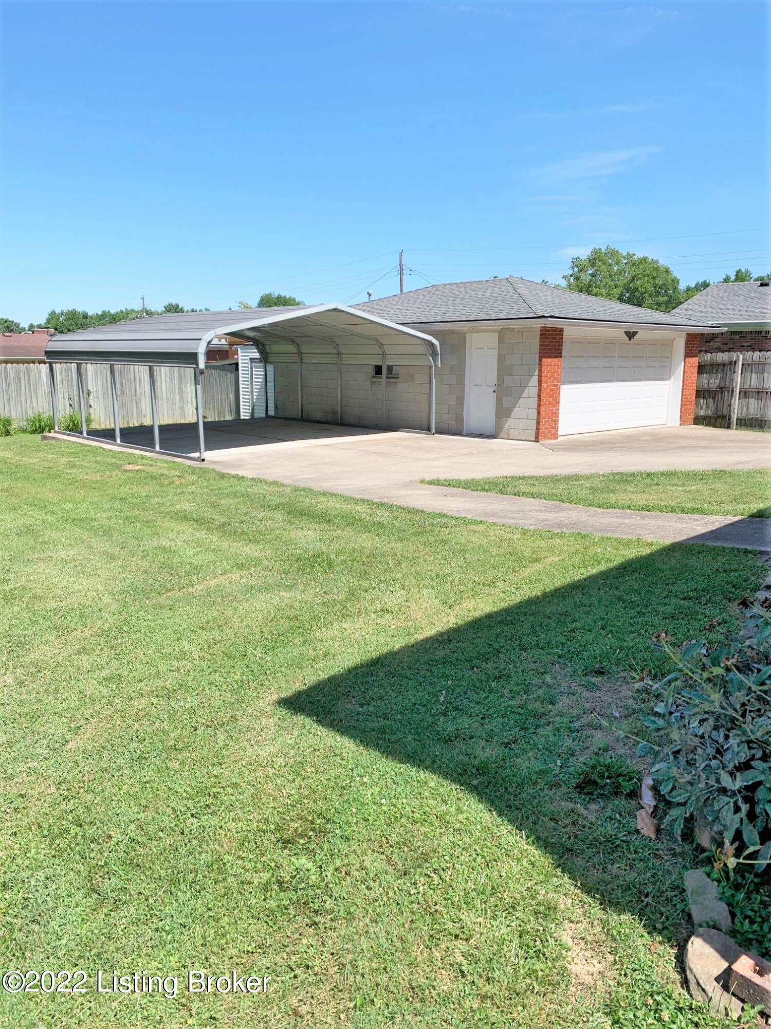 7002 Ledgerock Road Louisville, KY 40219 - Photo 6 of 28 2 1/2 car concrete block garage, 2 car carport. Sidewalk to house, attached shed behind garage.