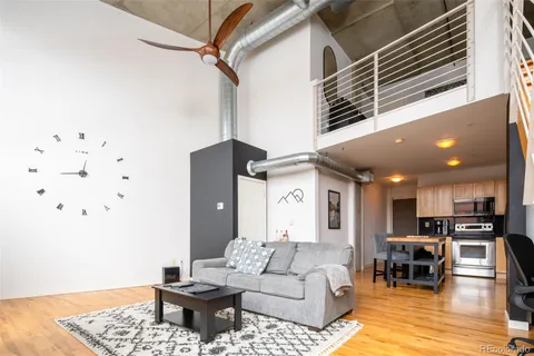 a living room with furniture and kitchen view