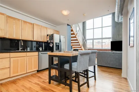 a kitchen with a table chairs sink and cabinets