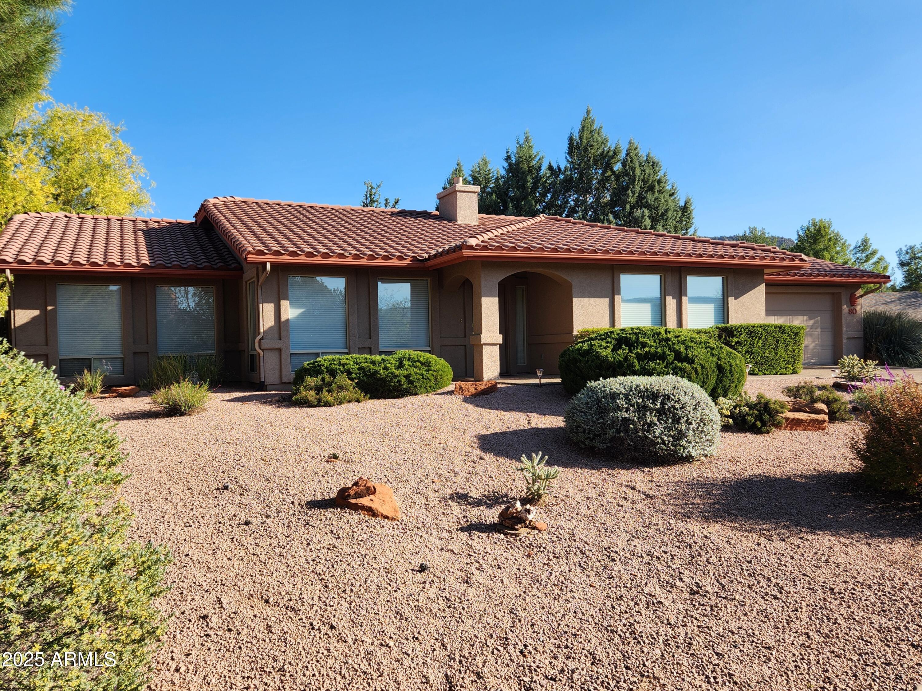 80 Stone Way Sedona, AZ 86351 - Photo 1 of 20 a view of a house with a yard and a bench