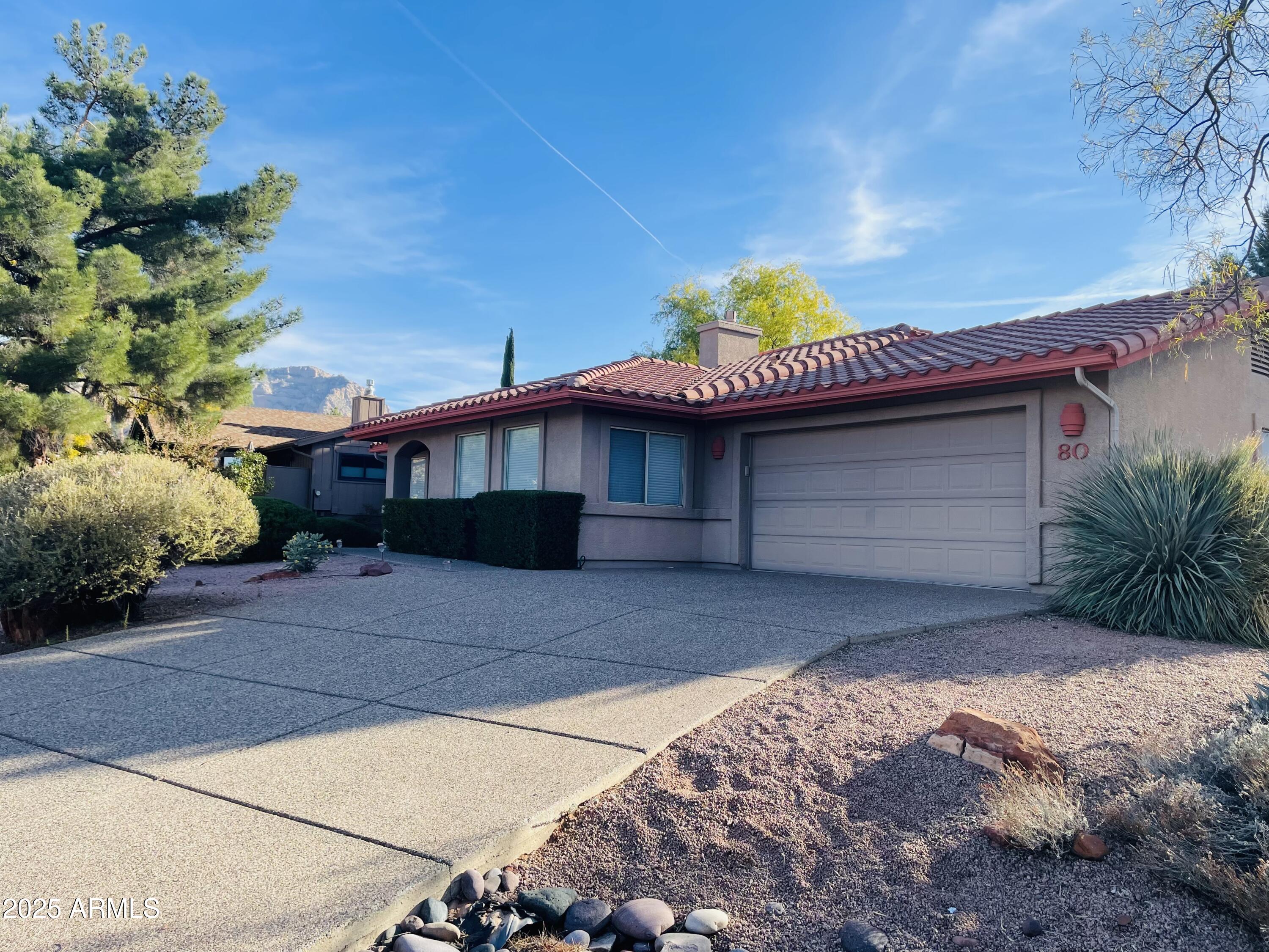 80 Stone Way Sedona, AZ 86351 - Photo 2 of 20 a front view of a house with a yard