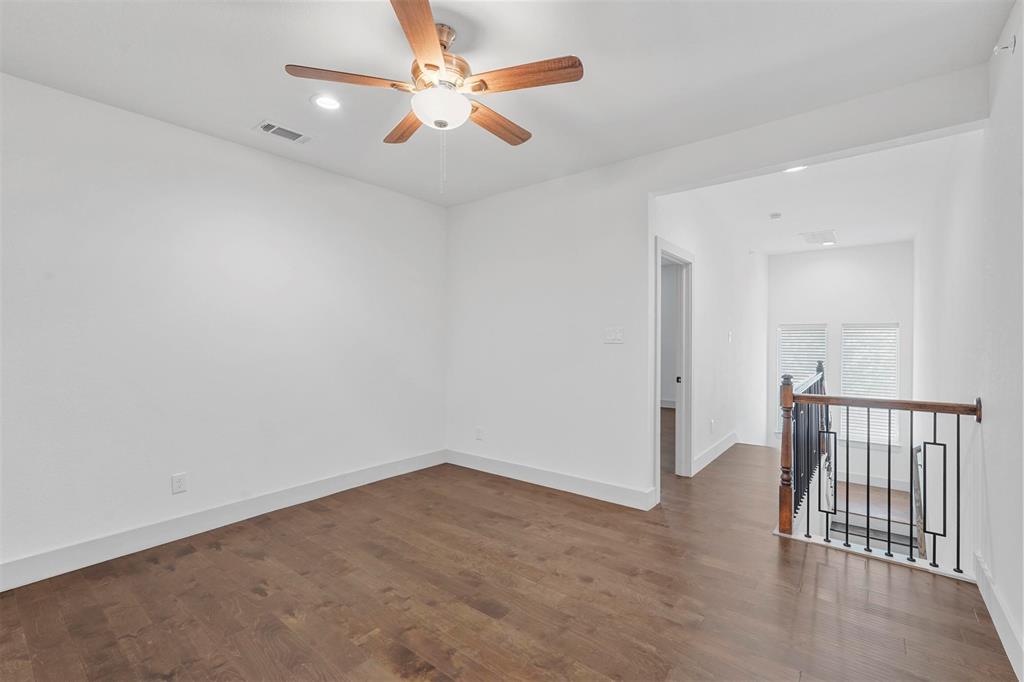 6059 Rivendell Drive Frisco, TX 75035 - Photo 12 of 30 an empty room with wooden floor and fan