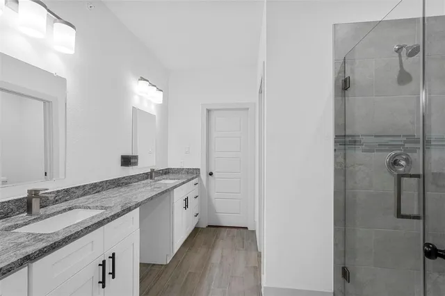 a bathroom with a granite countertop sink mirror and double