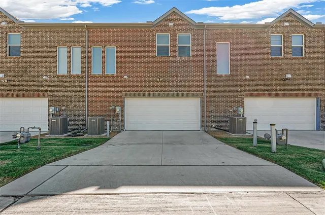 a front view of a house with a yard and a garage