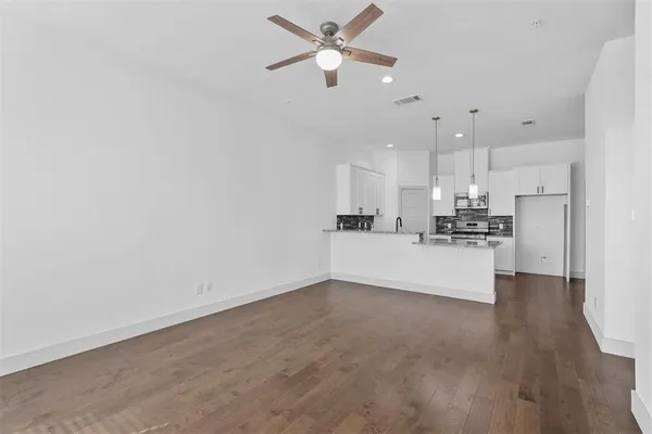 a view of kitchen with kitchen island stainless steel appliances sink and cabinets