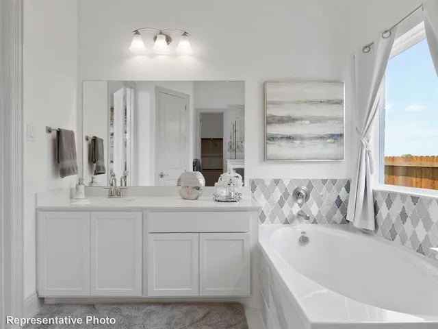 a bathroom with a bathtub sink and mirror