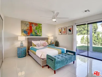 a bedroom with a bed and a large window