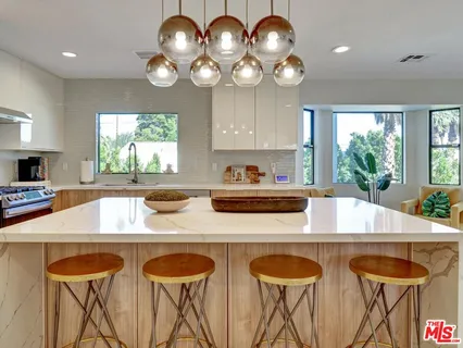 a kitchen with a table chairs and a large window