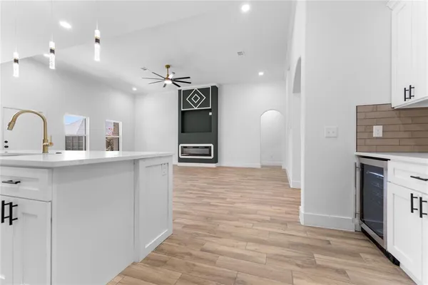 a view of a kitchen with a sink and a fireplace