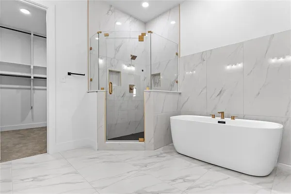 a white bath tub sitting next to a white sink