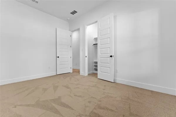 an empty room with closet area